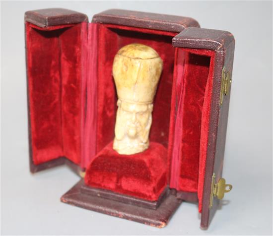 An early 19th century bone cane handle, 2.5in., in leather display case